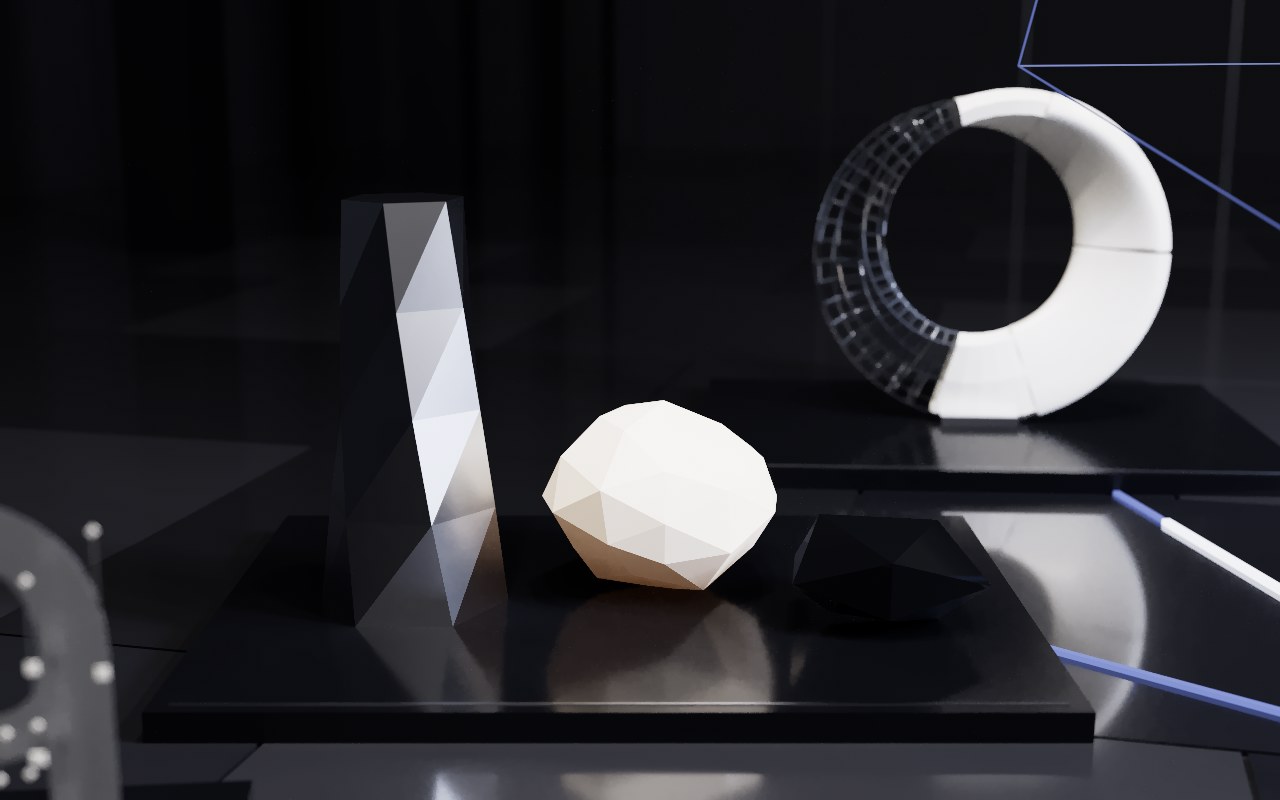 Three faceted studies on a stone plinth — brushed metal, translucent ceramic and polished stone — each answering the light differently.